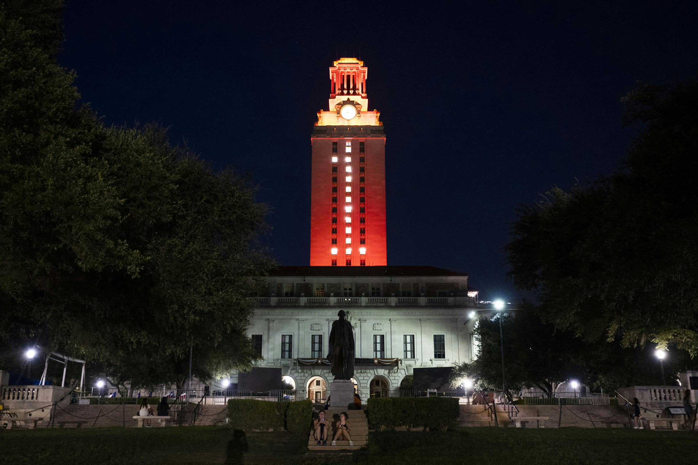 Photo of the UT Tower lit burnt orange with windows lit to form the number "1"