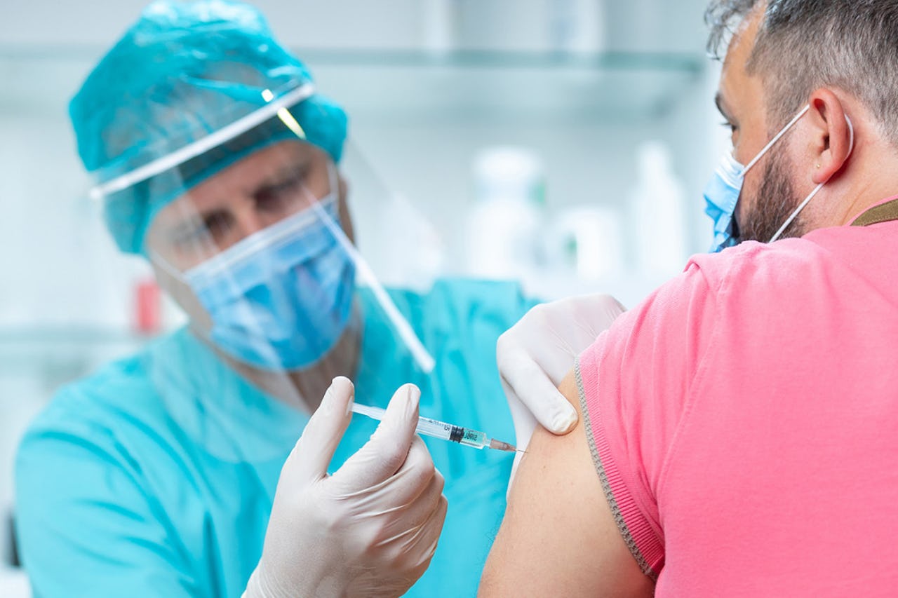 A medical professional vaccinates a patient