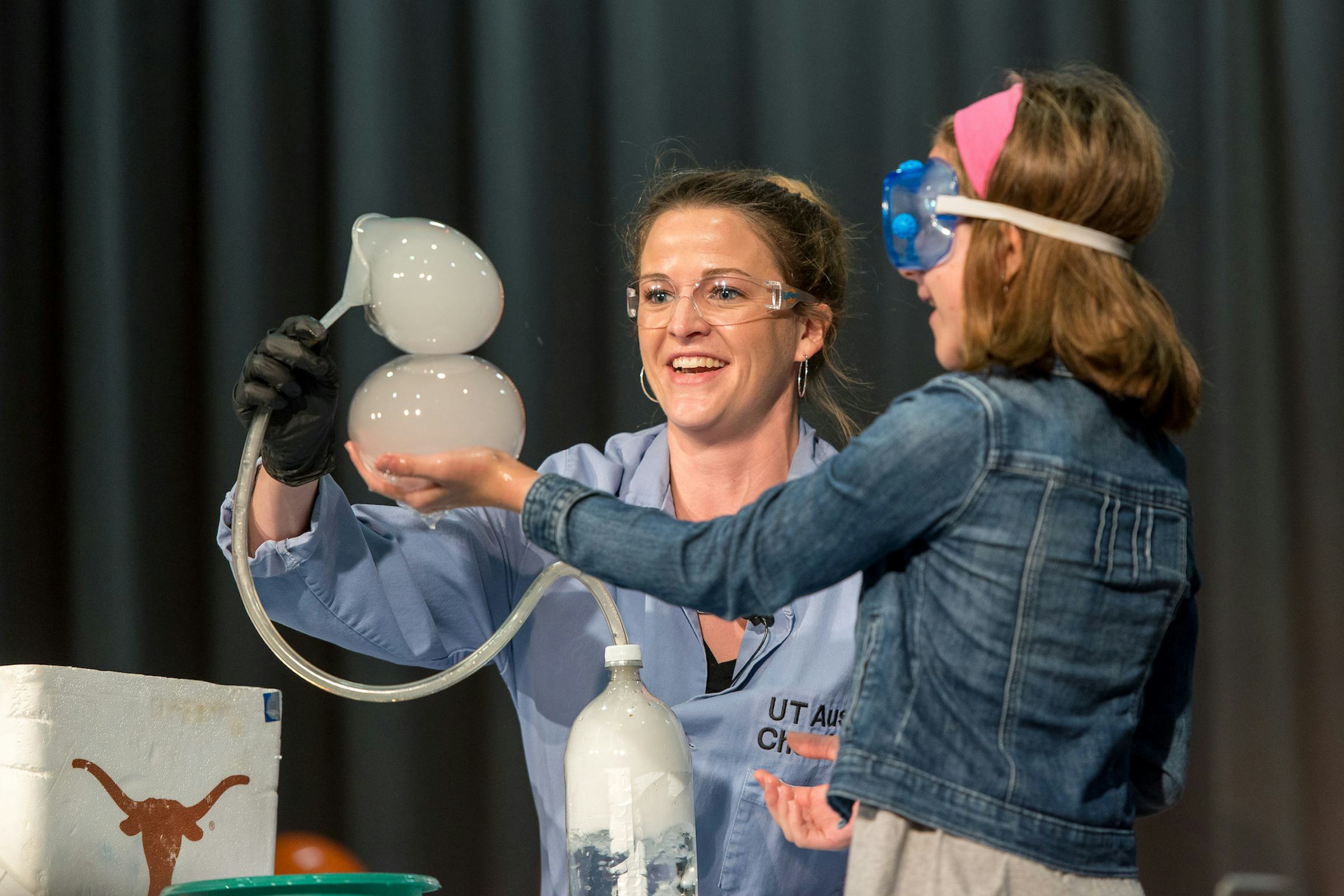 An elementary student marvels at a live chemistry demo with Kate the Chemist 