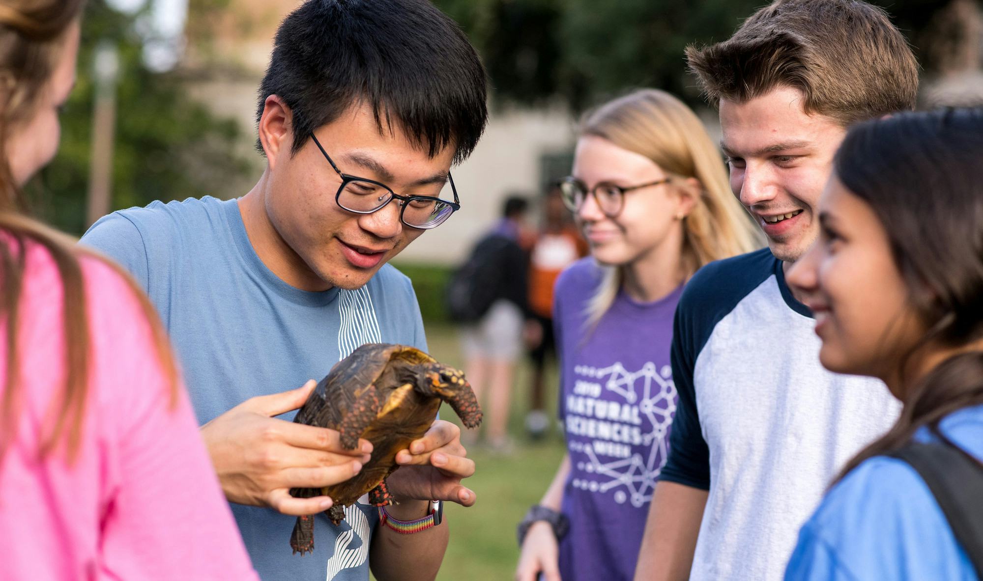 Student holding up a turtle