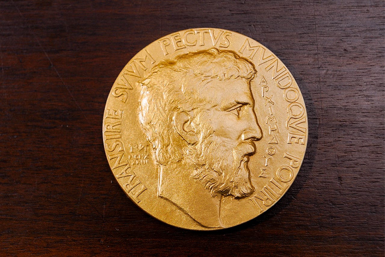 Fields Medal against a surface