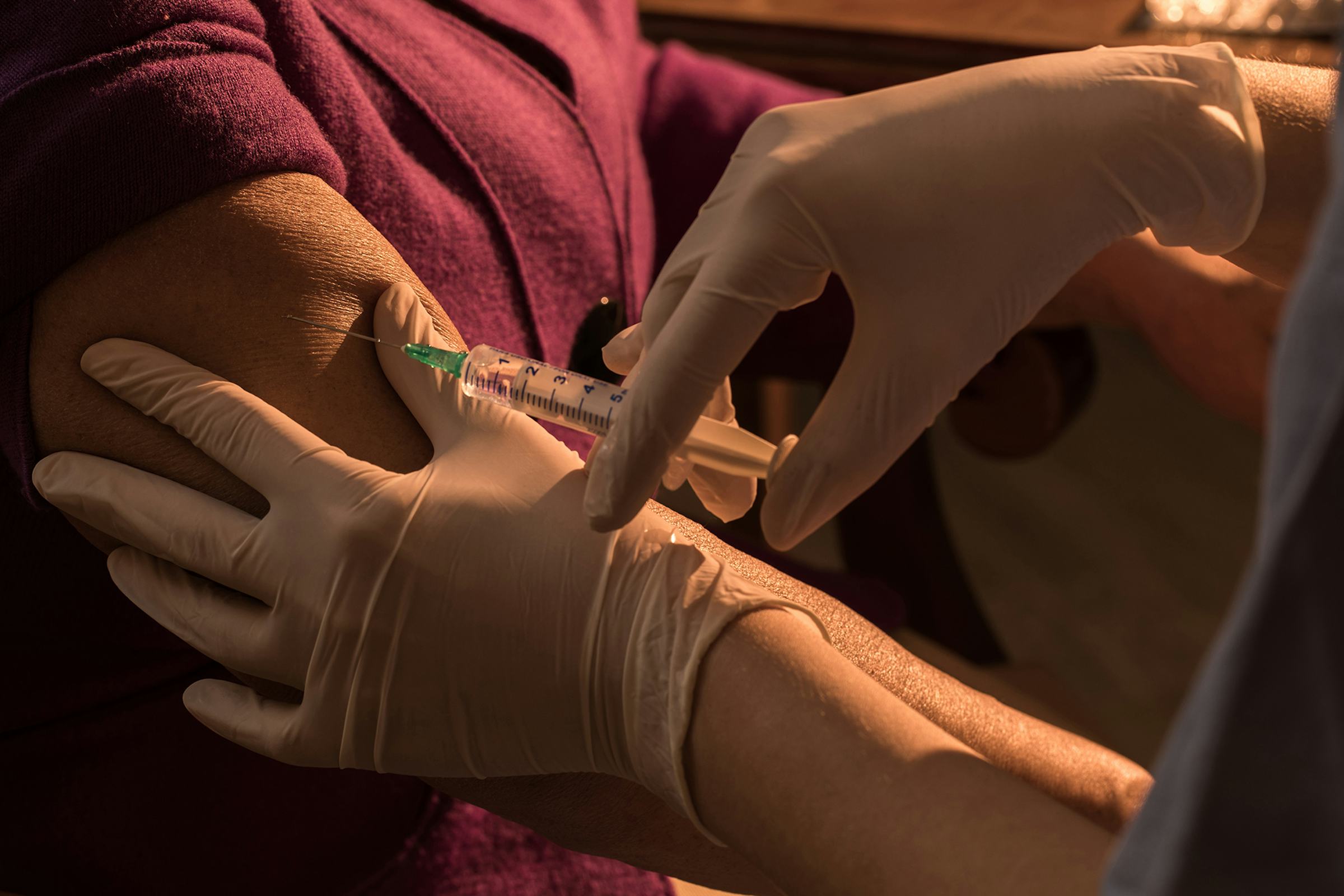 A patient receives a vaccination in the arm