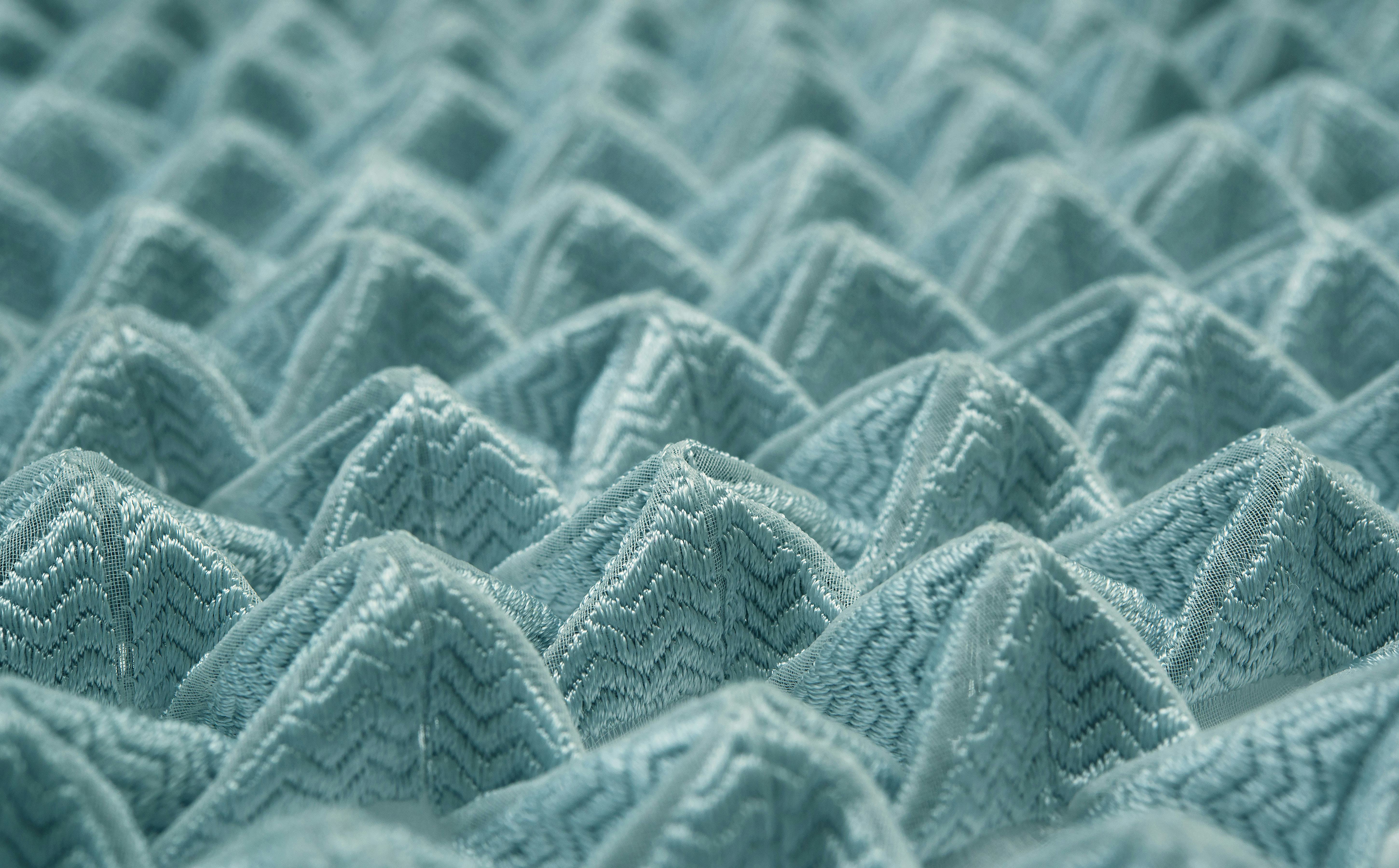 A close-up of a fabric that was embroidered using algorithmic design and patterning. 